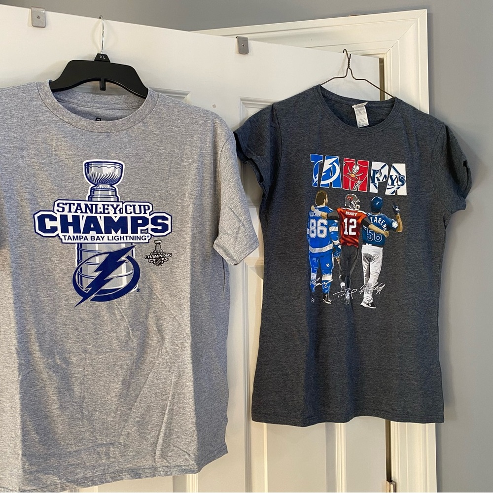 Ladies XL and men’s XL Tamp Bay Lightning Stanley cup t-shirts and a beanie hat.